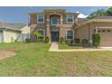 Inviting two-story home with a well-manicured lawn, beautiful landscaping, and an elegant entrance at 269 Englenook Dr, Debary, FL 32713