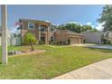 Well-maintained two-story home with a lush green lawn and mature landscaping at 269 Englenook Dr, Debary, FL 32713