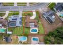 Aerial view showcases a backyard pool, well-maintained lawn, and convenient driveway at 275 Tollgate Trl, Longwood, FL 32750