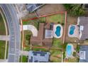 Aerial view of home featuring a backyard pool, lush lawn, and a private driveway at 275 Tollgate Trl, Longwood, FL 32750