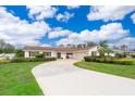 Inviting single-story home featuring a circular driveway and well-maintained landscaping, including lush green grass and shrubbery at 275 Tollgate Trl, Longwood, FL 32750