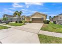 Street view of a well-maintained single-Gathering home with a lush lawn, 2 car garage, and sidewalks at 2815 Shelburne Way, St Cloud, FL 34772