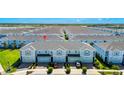 Spacious townhome community showcasing well-maintained landscaping, attached garages, and convenient neighborhood layout at 2919 Verse St, Kissimmee, FL 34746