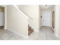 Inviting foyer with tile flooring, staircase, and a view of the front door at 2919 Verse St, Kissimmee, FL 34746