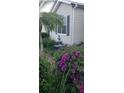 Beautiful landscaping with vibrant purple flowers and a decorative fountain in the front yard at 3700 Plantation Blvd, Leesburg, FL 34748