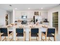Modern kitchen featuring stainless steel appliances, a large island, and an adjacent pantry at 4760 Yellow Elder Way, Kissimmee, FL 34758