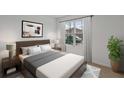 Bright bedroom featuring neutral tones, large window, and modern decor at 5067 Tana Ter, St Cloud, FL 34772