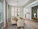 Elegant dining room with a modern chandelier, neutral colors, and ample natural light at 5242 Citrus Leaf, Winter Garden, FL 34787