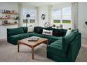Comfortable living room with a large green sectional sofa and bright natural light at 5242 Citrus Leaf, Winter Garden, FL 34787