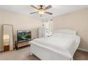 Bright bedroom features a large bed, neutral tones, and ample natural light at 7349 Ella Ln, Windermere, FL 34786