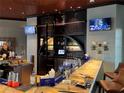 Upscale bar area featuring a marble countertop, dark wood accents, multiple TVs, and premium liquor displays at 7518 Seven Eagles Way # 201, Reunion, FL 34747