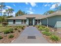 Inviting single-story home with a lush front yard and well-maintained walkway at 8660 Sw 137Th Ct, Dunnellon, FL 34432