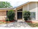 Close-up of the front door with mature bushes at 100 Crestwood Dr, Longwood, FL 32779