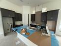 Modern kitchen with sleek, dark cabinetry, a stylish backsplash, and spacious countertop island at 10043 Dulbecco St, Orlando, FL 32827