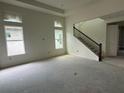 Spacious living room features ample natural light and staircase access at 10043 Dulbecco St, Orlando, FL 32827