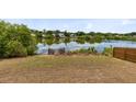 Waterfront backyard with lake views and a wooden pier, perfect for relaxation at 1103 Saddleback Ridge Rd, Apopka, FL 32703