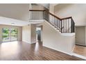 Inviting living room features wood floors, a staircase, and scenic lake views at 1103 Saddleback Ridge Rd, Apopka, FL 32703