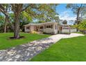 Charming single-story home with a long driveway leading to a covered carport at 1121 Magnolia Ave, Daytona Beach, FL 32114