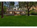 Charming home with a well-manicured lawn and inviting front porch at dusk at 1121 Magnolia Ave, Daytona Beach, FL 32114