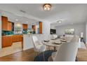 Dining room with a marble table, seating for four, and an open view of the kitchen at 1231 Glastonberry Rd, Maitland, FL 32751