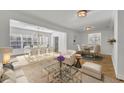 Bright, open-concept living room and dining area with hardwood floors and stylish furnishings at 1231 Glastonberry Rd, Maitland, FL 32751