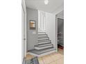 Inviting foyer showcasing stairs, coat closet, and bright, neutral color palette at 135 Orchid Dr, Davenport, FL 33897