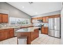 Modern kitchen featuring stainless steel appliances, granite countertops, and a center island at 143 Abbey Hollow Dr, Apopka, FL 32712