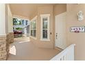 Close-up of the inviting covered front porch with stone columns, offering a welcoming entrance to the home at 14537 Cheever St, Orlando, FL 32828