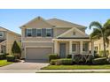 Charming two-story home with a manicured lawn and inviting brick driveway on a sunny day at 14742 Bahama Swallow Blvd, Winter Garden, FL 34787