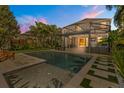 Inviting in-ground pool featuring a modern tile surround and covered outdoor patio with grill at 14742 Bahama Swallow Blvd, Winter Garden, FL 34787