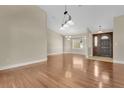 Spacious foyer and dining area with sleek hardwood floors, neutral walls, and a decorative light fixture at 1512 Adriatic Dr, Ocoee, FL 34761