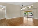 Bright living room featuring hardwood floors, lots of natural light, and sliding glass doors to the pool at 1512 Adriatic Dr, Ocoee, FL 34761