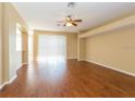 Spacious living room with hardwood flooring, ceiling fan, and sliding glass doors to the exterior at 173 Donner Dr, Winter Garden, FL 34787