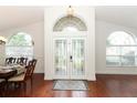 Inviting foyer with double front doors, hardwood floors, and lots of natural light at 1937 Crystal Downs Ct, Oviedo, FL 32765