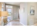 Bright entryway with decorative tile flooring, artwork, and a glass front door to allow lots of natural light at 194 Amberwood Way, Umatilla, FL 32784