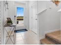 Bright foyer with tile floors, a decorative table, and a view of the front door at 2052 Monteverde Ave, Davenport, FL 33837