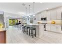 Open-concept kitchen with a large island, granite countertops, and stainless steel appliances at 2127 Bay Line Rd, Oakland, FL 34787