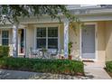 Townhouse porch featuring an intimate seating area and neat landscaping at 2203 Gopher Tortoise Ter, Oakland, FL 34787