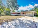 Charming single-story home featuring a brick accent wall, a well-manicured lawn, and an attached garage at 2631 Mcdonald Ter, Mount Dora, FL 32757
