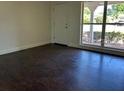 Bright living room with dark floors, showcasing a large window offering ample natural light and airy feel at 2886 Carew Ave, Winter Park, FL 32789