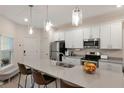 Modern kitchen featuring stainless steel appliances, a large island, and pendant lighting at 2956 Oak Park Way # B, Orlando, FL 32822