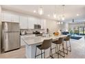 Modern kitchen featuring stainless steel appliances, a large island, and bar stool seating at 2956 Oak Park Way # B, Orlando, FL 32822