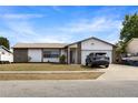 Charming single-story home featuring a well-maintained lawn and an attached garage at 3041 Dikewood Ct, Winter Park, FL 32792