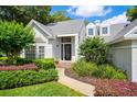 Charming front entrance featuring a well-maintained lawn and inviting walkway leading to the front door at 308 Pine Shadow Ln, Lake Mary, FL 32746