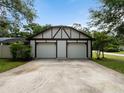 Spacious two-car garage with Tudor-style accents and a concrete driveway at 3420 Dawn Ct, Lake Mary, FL 32746