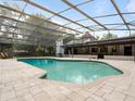 Backyard pool features screen enclosure and stone tiled patio at 3420 Dawn Ct, Lake Mary, FL 32746