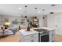 Modern kitchen boasts a large center island with pendant lighting, stainless steel appliances, and open living area at 356 Oakhurst St, Altamonte Springs, FL 32701