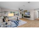 Bright living room with wood floors, contemporary decor, and a large window offering natural light at 356 Oakhurst St, Altamonte Springs, FL 32701