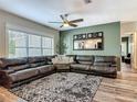 Comfortable living room with large windows, ceiling fan, and sectional sofa, perfect for relaxation at 39 Lake Dr, Debary, FL 32713
