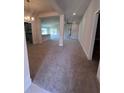 Spacious open-concept living area with neutral carpet, recessed lighting, and a view of the kitchen at 4264 Sagefield Dr, St Cloud, FL 34773